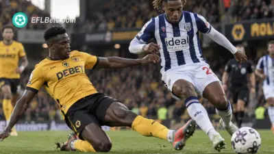 Munetsi of Wolves, sliding into a ferocius tackle with Nzingoula of West Brom