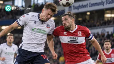 Sam Dalby of Bolton, competing for a header with Luke Ayling of Middlesbrough, in a packed Toughsheet Community Stadium