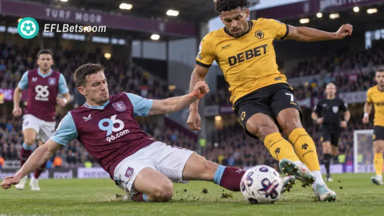 Josh Cullen of Burnley, making an sliding tackle vs André of Wolves in a packed Turf Moor Stadium