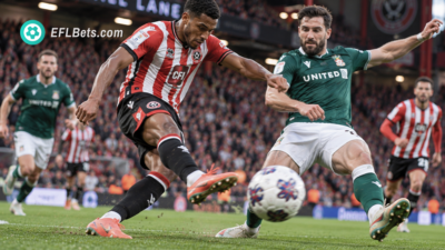Sam McCallum of Sheffield Utd getting a shot away as Dominic Hyam of Wrexham attempts to block