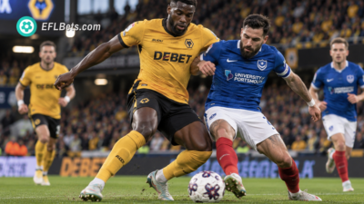 Toti Gomes of Wolves, jostling for the ball with Marlon Pack of Portsmouth